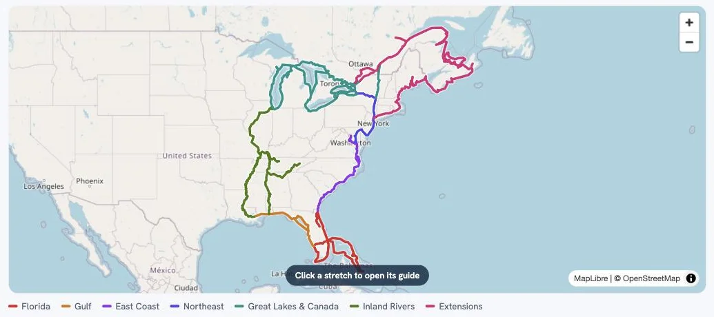 The Waterway Guides map — the Great Loop route drawn in seven region colors from Florida to the Extensions, with a legend beneath and a hint that reads: click a stretch to open its guide.